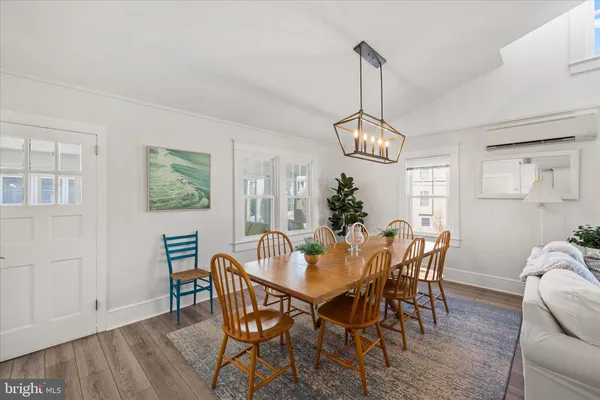a view of a dining room with furniture and a chandelier
