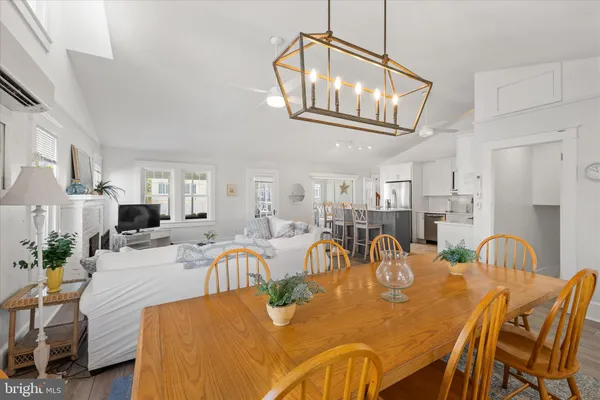 a open kitchen with white cabinets and wooden floor