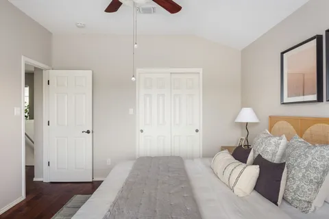 a bedroom with a bed and wooden floor