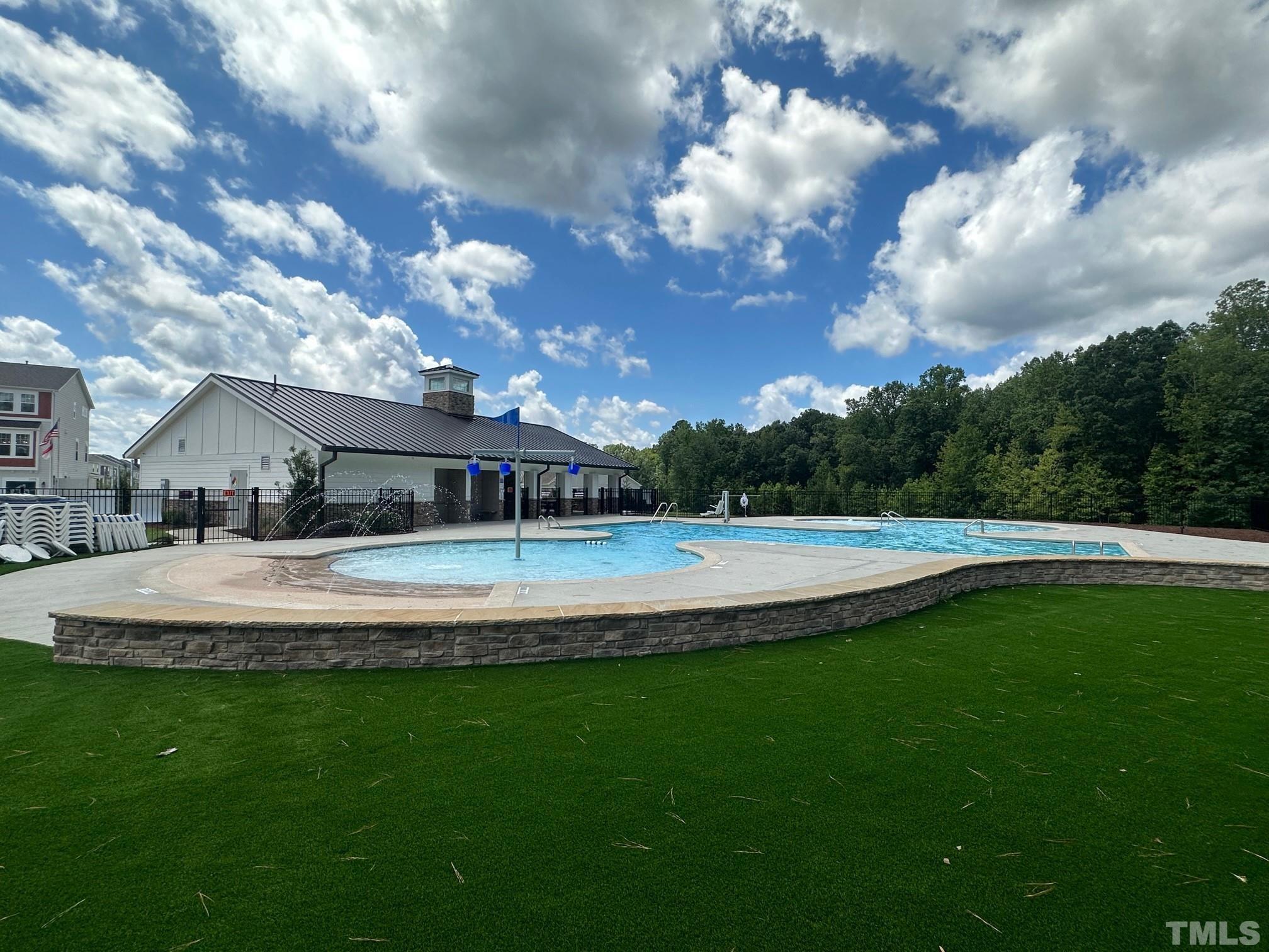 2225 Kettle Falls Station, Unit 392 Apex, NC 27502 - Photo 17 of 52 a view of a house with swimming pool and a yard