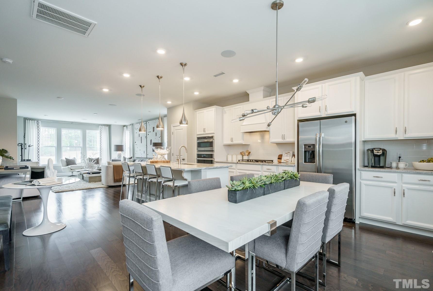 2225 Kettle Falls Station, Unit 392 Apex, NC 27502 - Photo 31 of 52 a kitchen with counter space dining table and chairs
