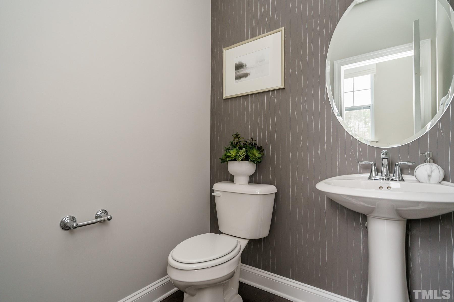 2225 Kettle Falls Station, Unit 392 Apex, NC 27502 - Photo 33 of 52 a bathroom with a toilet sink and mirror