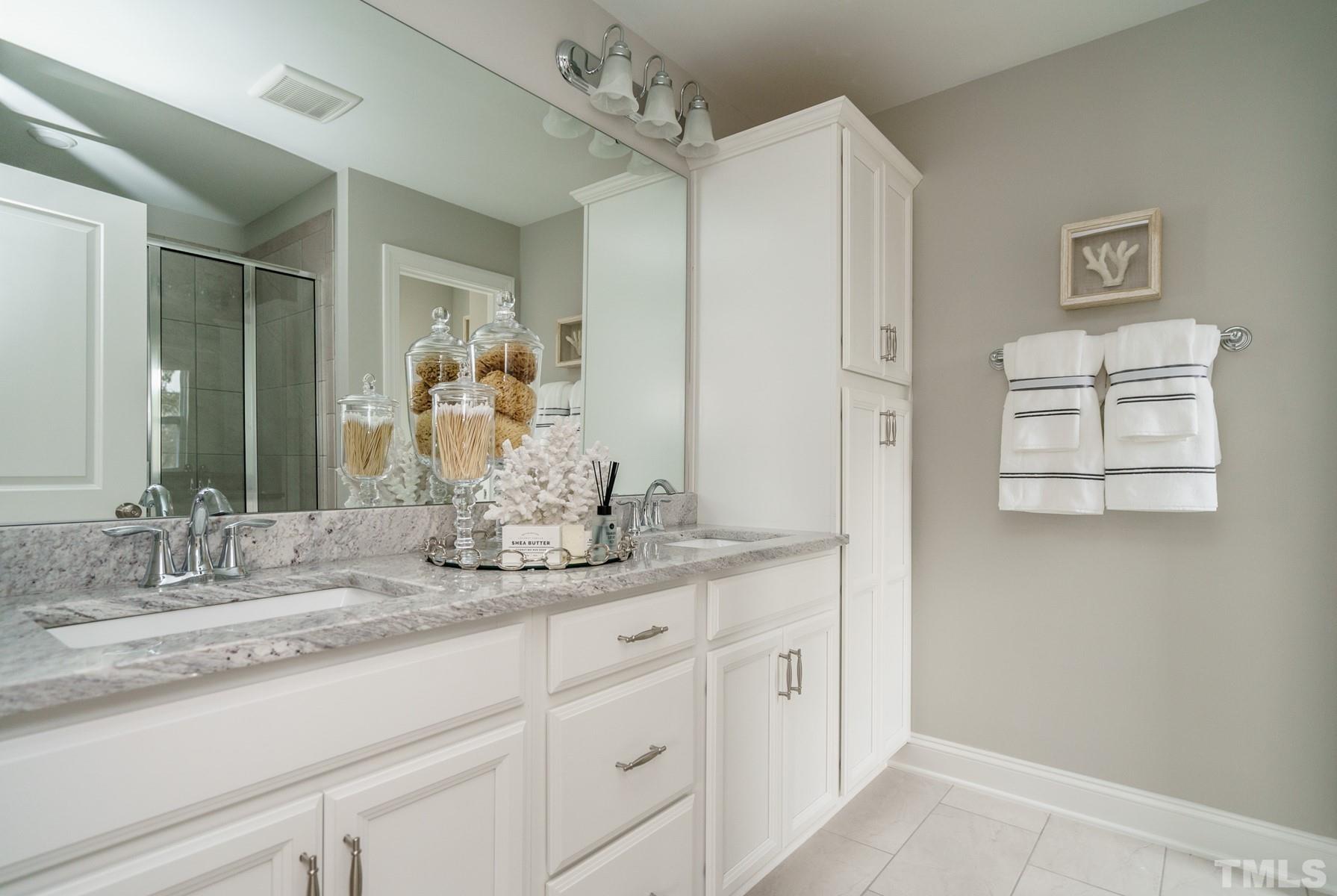2225 Kettle Falls Station, Unit 392 Apex, NC 27502 - Photo 37 of 52 a bathroom with a granite countertop sink a mirror and a shower