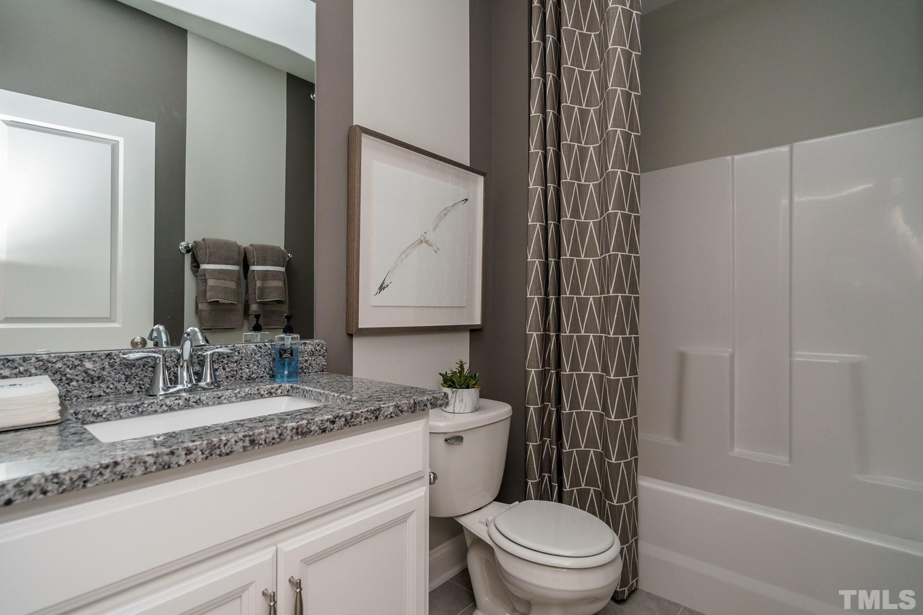 2225 Kettle Falls Station, Unit 392 Apex, NC 27502 - Photo 47 of 52 a bathroom with a sink a toilet and shower