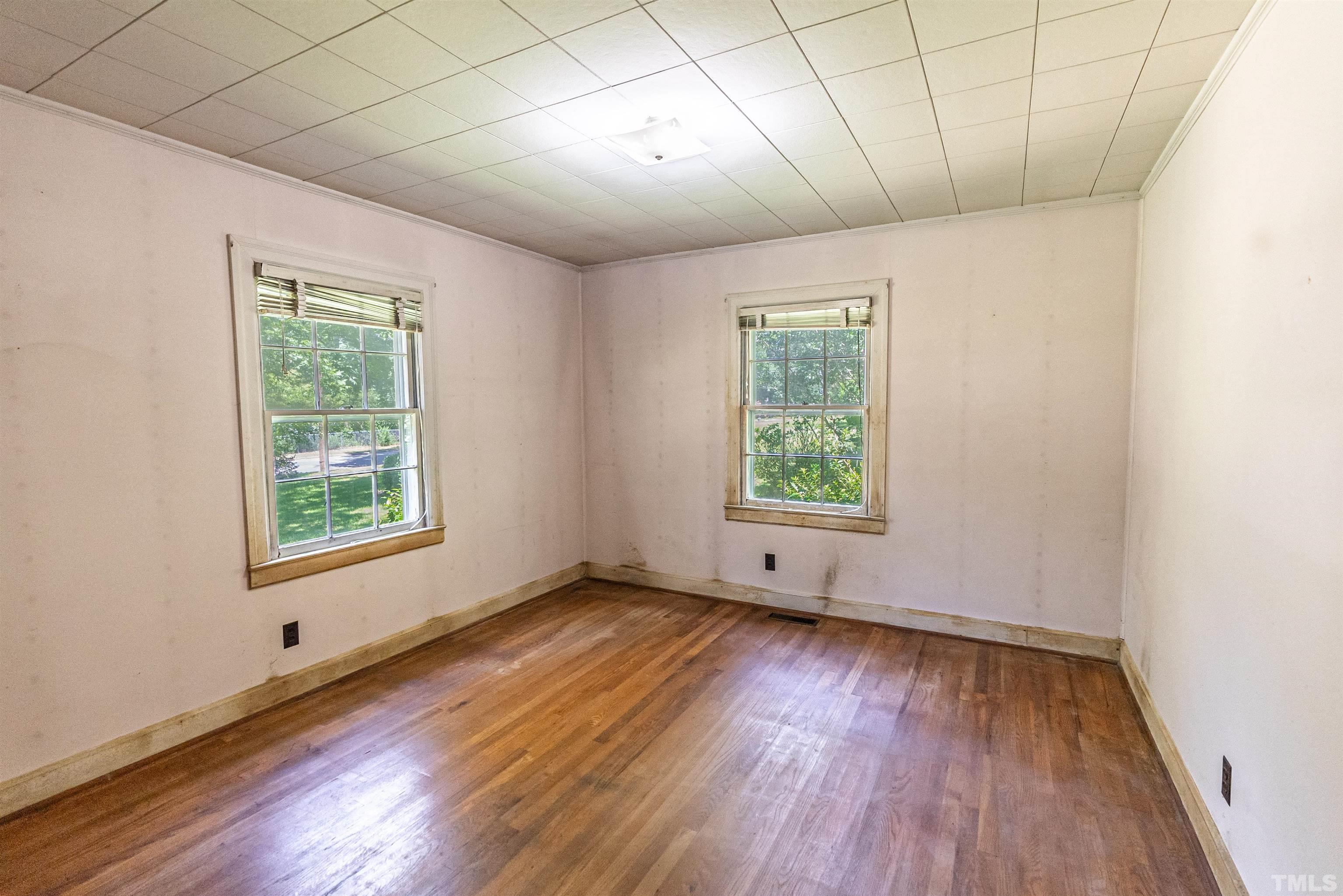 457 Rose Lane Raleigh, NC 27610 - Photo 11 of 26 a view of an empty room with wooden floor and a window