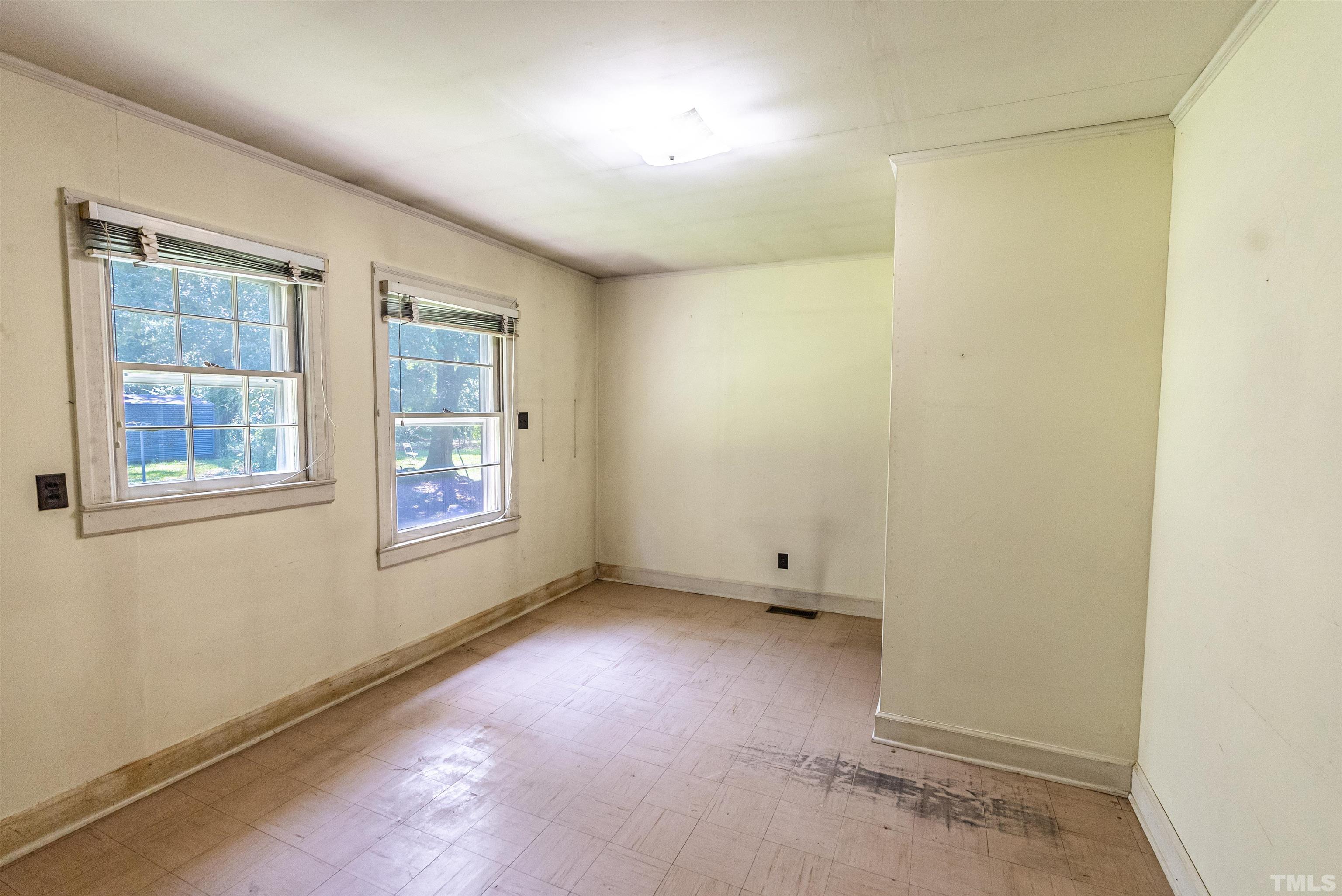 457 Rose Lane Raleigh, NC 27610 - Photo 13 of 26 an empty room with windows
