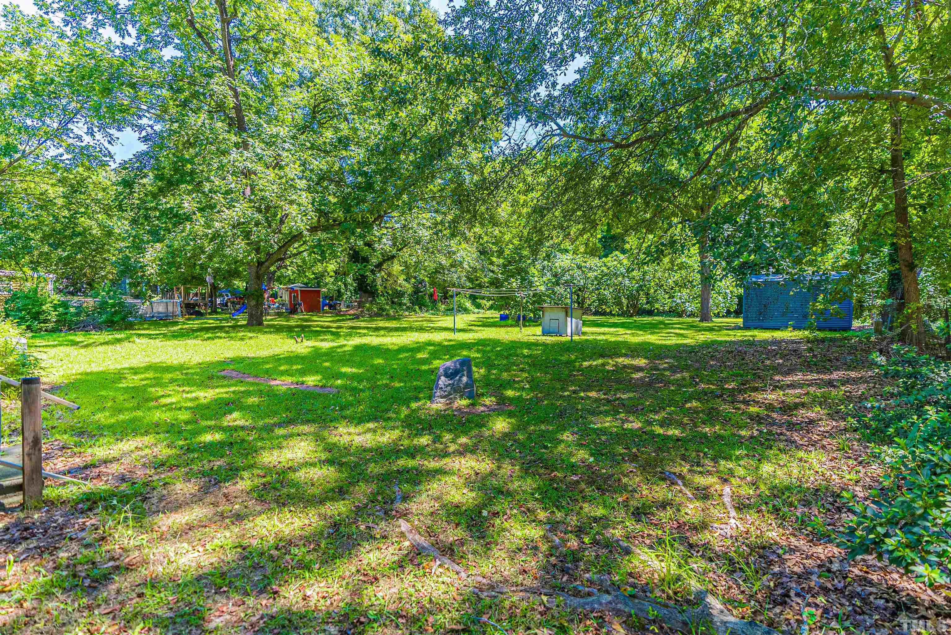 457 Rose Lane Raleigh, NC 27610 - Photo 18 of 26 a big yard with lots of green space and plants