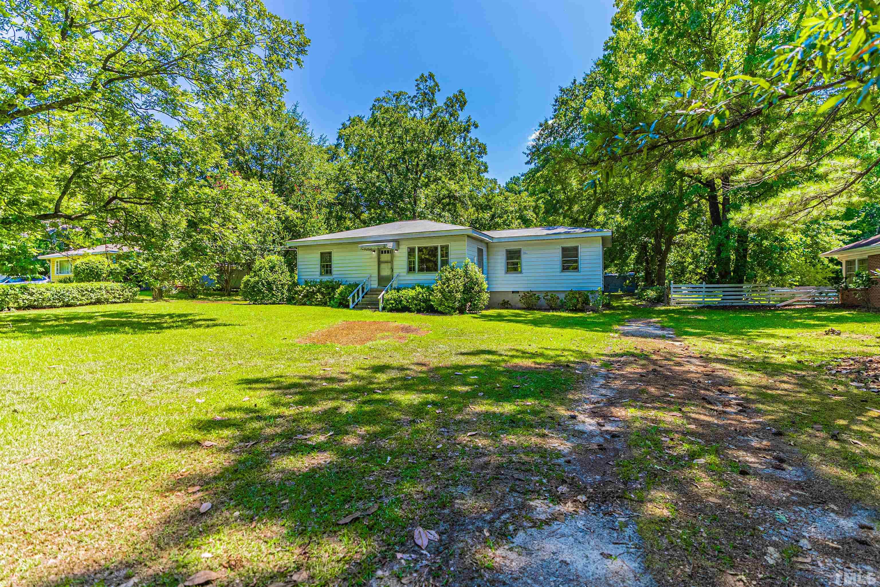 457 Rose Lane Raleigh, NC 27610 - Photo 2 of 26 a view of a house with a big yard
