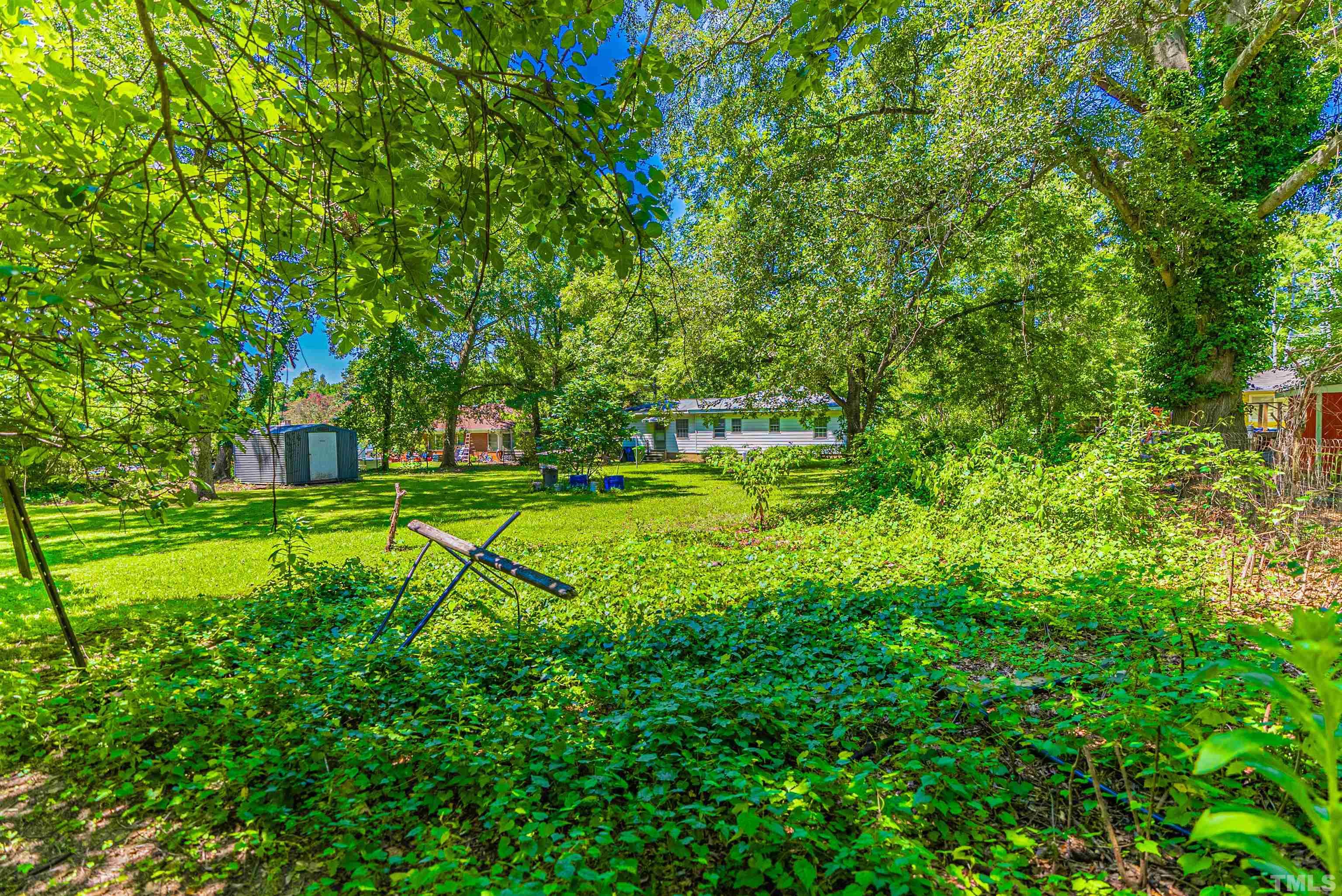 457 Rose Lane Raleigh, NC 27610 - Photo 21 of 26 a view of a house with a big yard