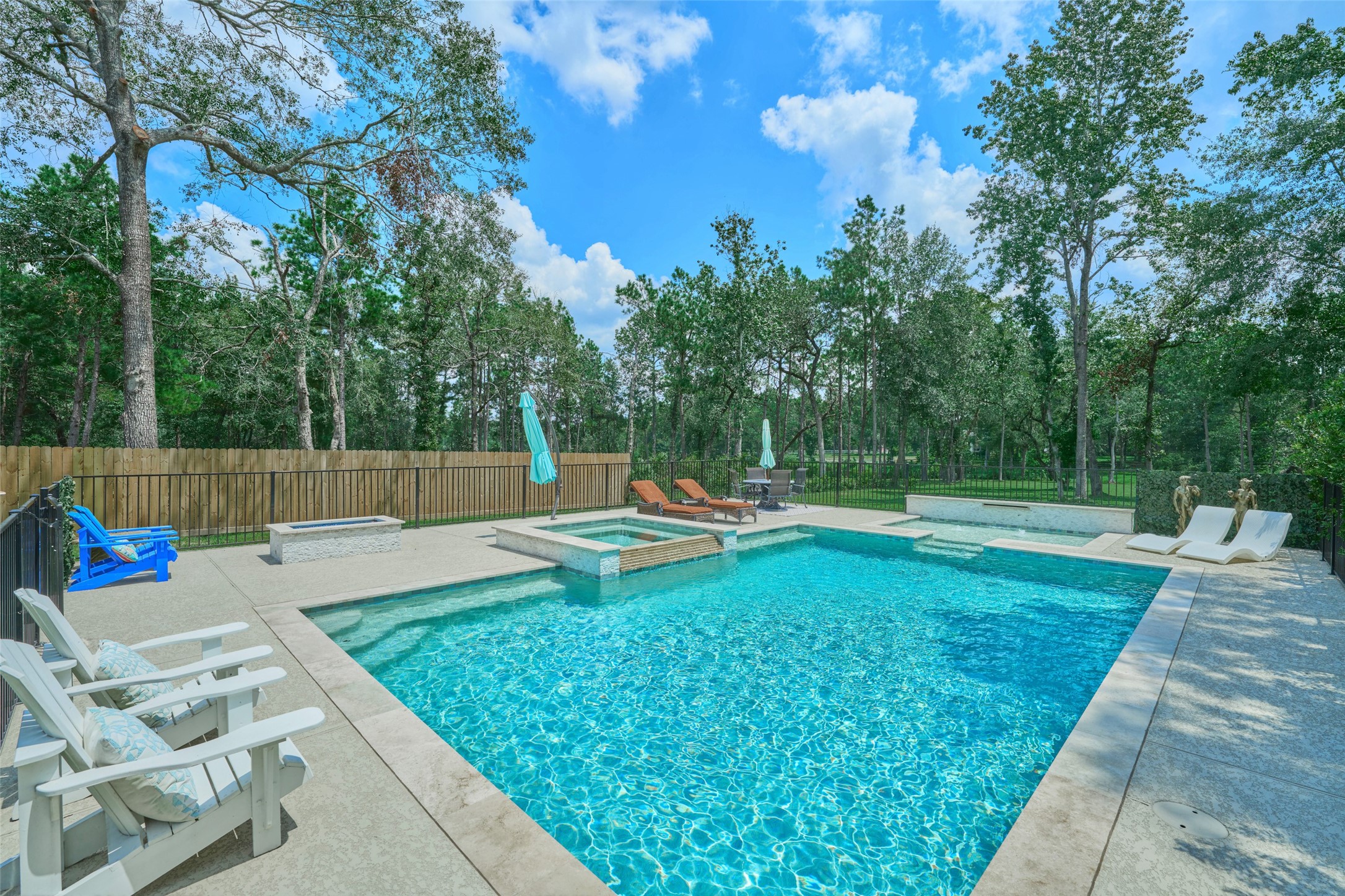 2218 Honea Egypt Road Magnolia, TX 77354 - Photo 16 of 50 Indulge in the luxury of a pristine saltwater pool, nestled in a tranquil, private backyard oasis.