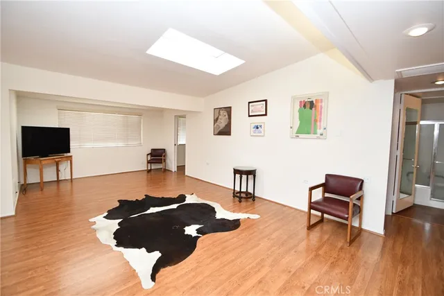 a living room with furniture and a dining table with kitchen view