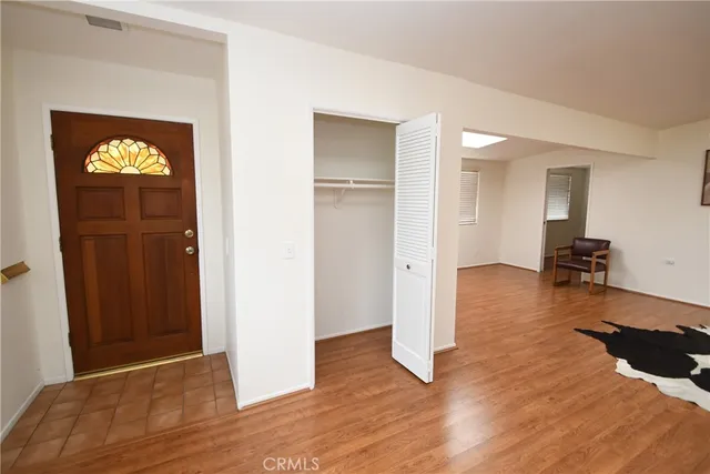a view of a livingroom with wooden floor and lounge chair