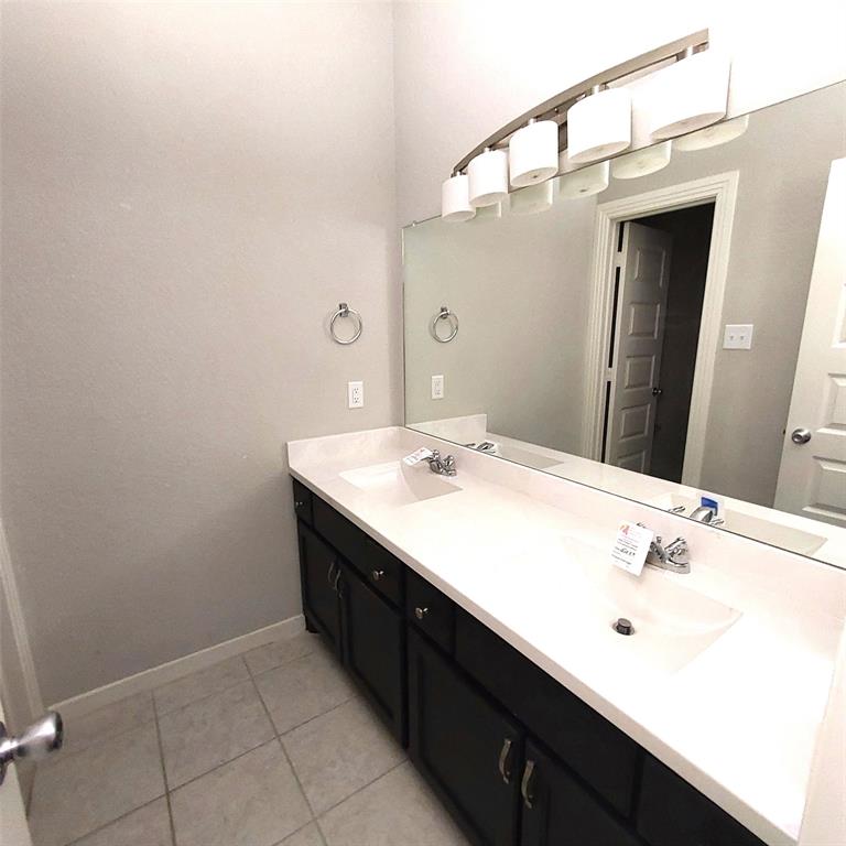 1813 Huntsman Way Forney, TX 75126 - Photo 15 of 18 a bathroom with a sink and a mirror