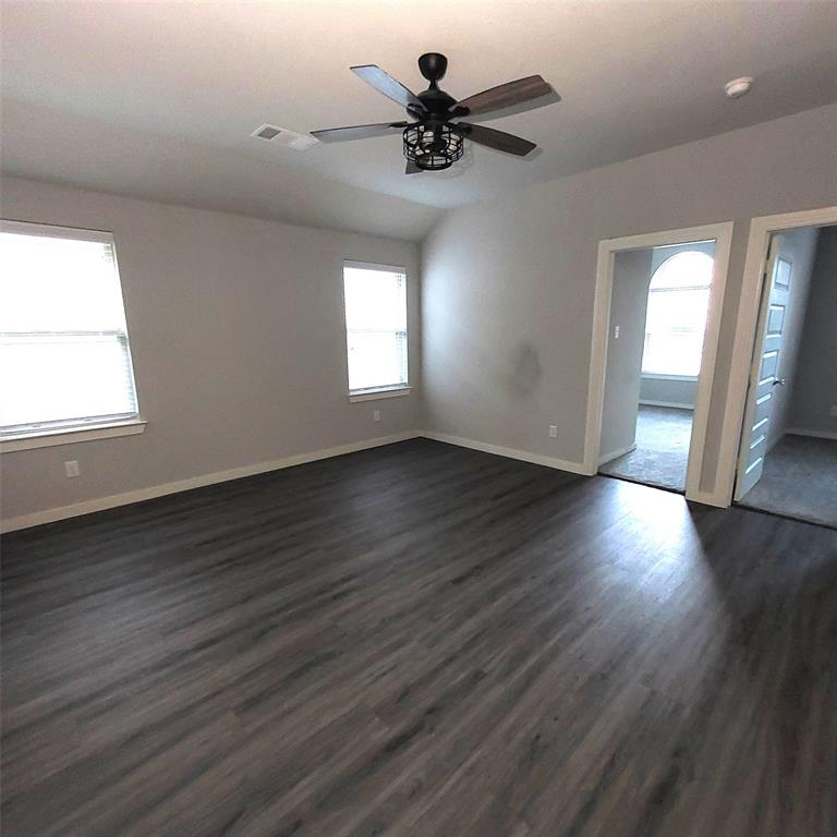 1813 Huntsman Way Forney, TX 75126 - Photo 5 of 18 an empty room with wooden floor and windows