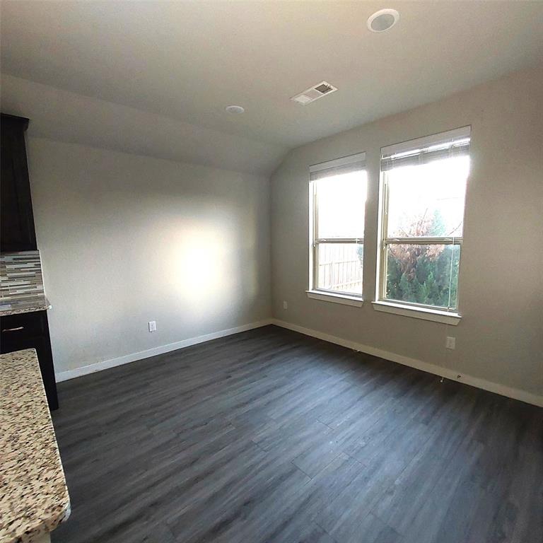 1813 Huntsman Way Forney, TX 75126 - Photo 8 of 18 an empty room with wooden floor and windows