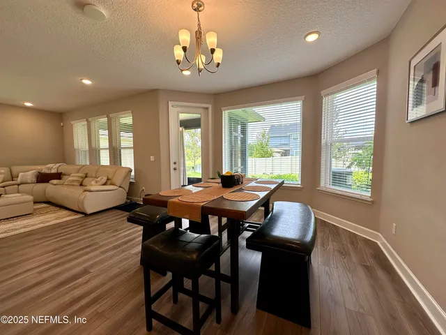 a large kitchen with stainless steel appliances kitchen island a large counter top and a refrigerator