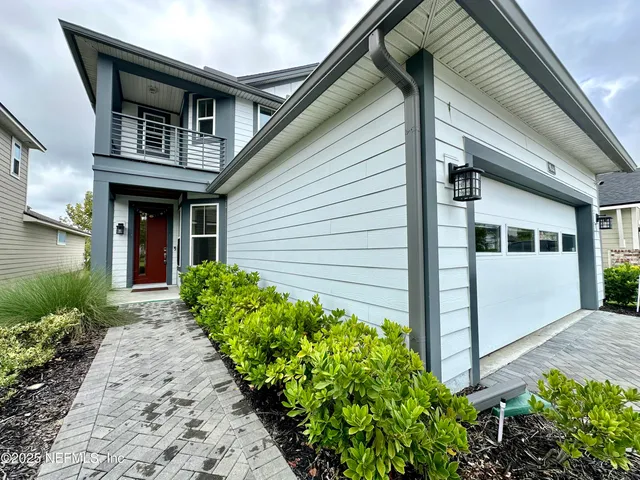 a front view of a house with garden