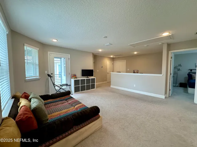 a gym room with gym equipment and a large window