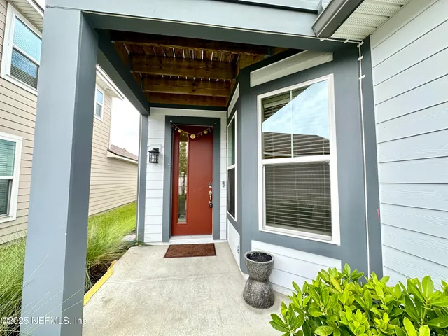 a view of porch with a door and wooden floor