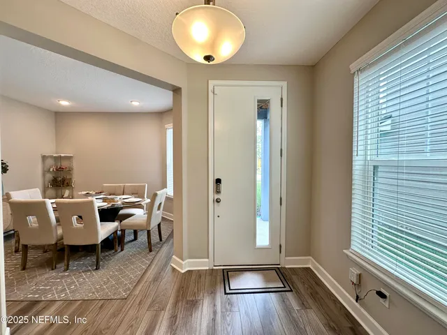 a dining room with furniture a window and a kitchen