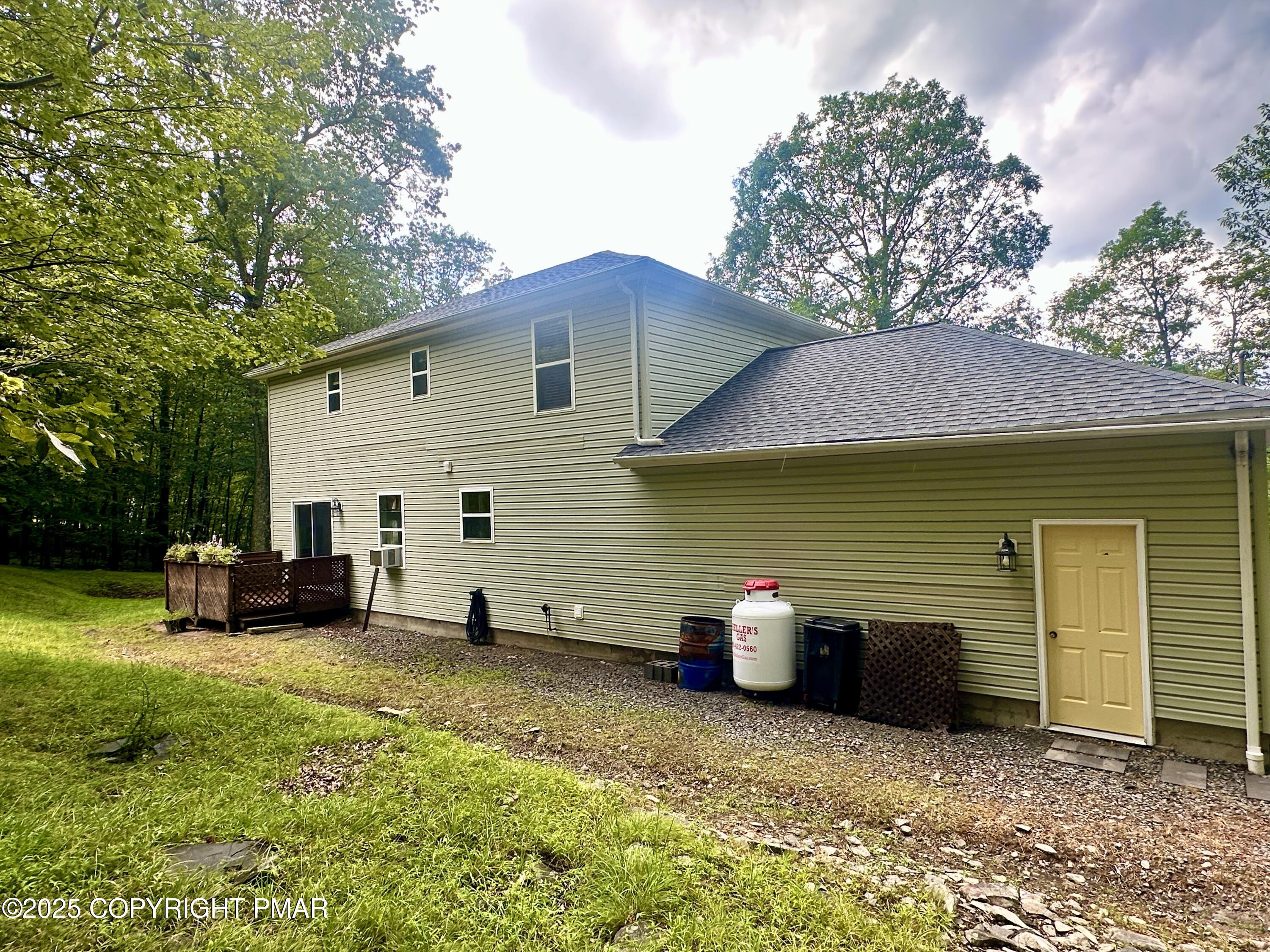 164 Alpine Road Henryville, PA 18332 - Photo 4 of 49 a view of a house with a patio and a yard
