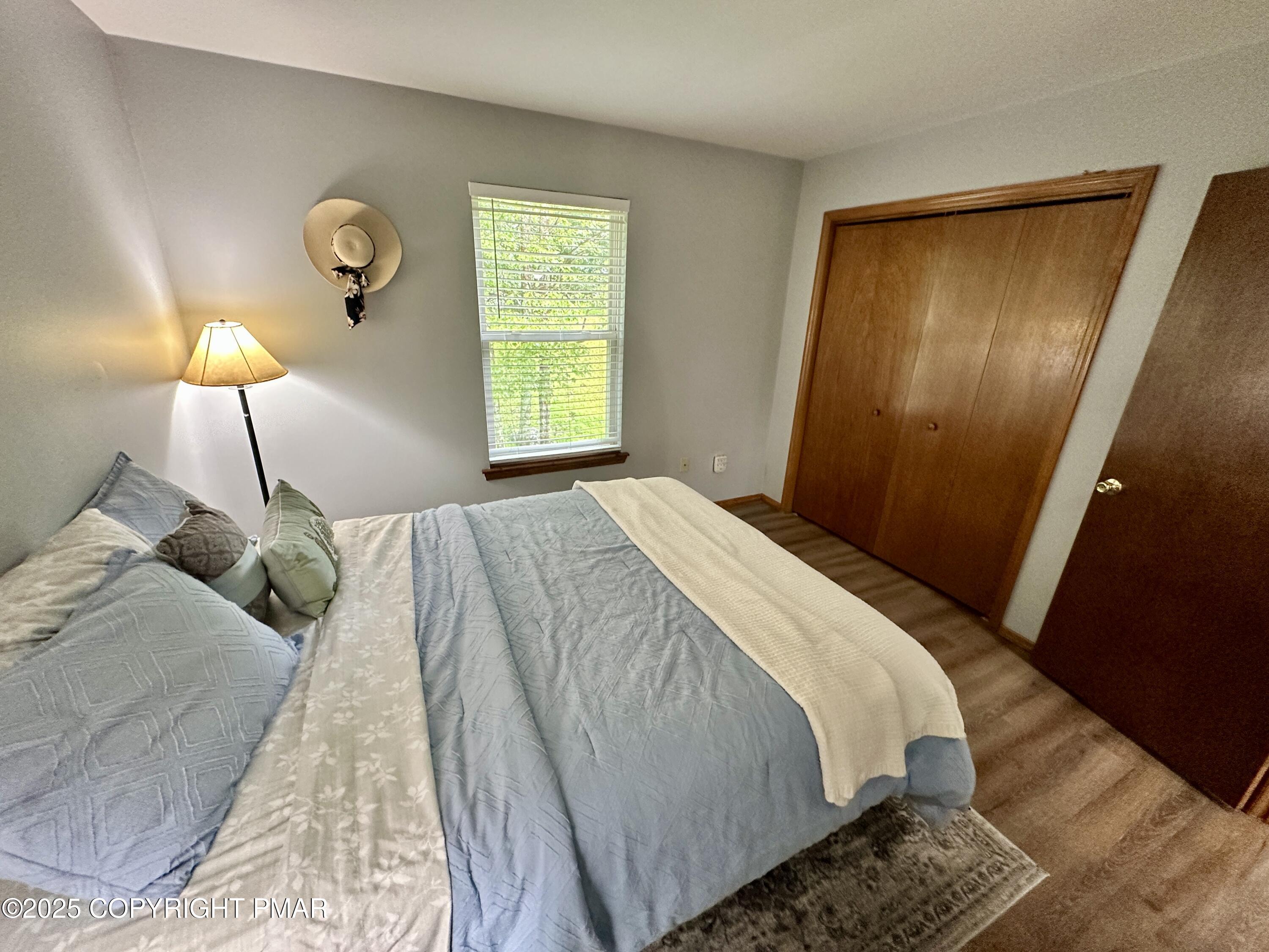 164 Alpine Road Henryville, PA 18332 - Photo 47 of 49 a bed sitting in a bedroom next to a window and a lamp