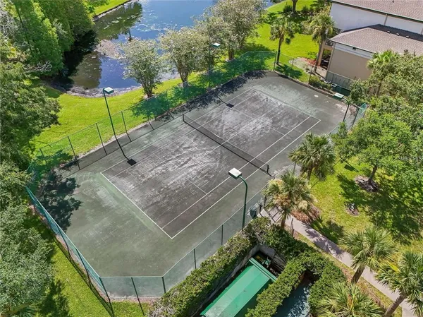 an aerial view of a house with garden space and a patio