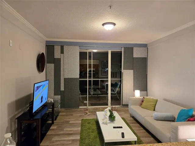 a living room with furniture and a floor to ceiling window