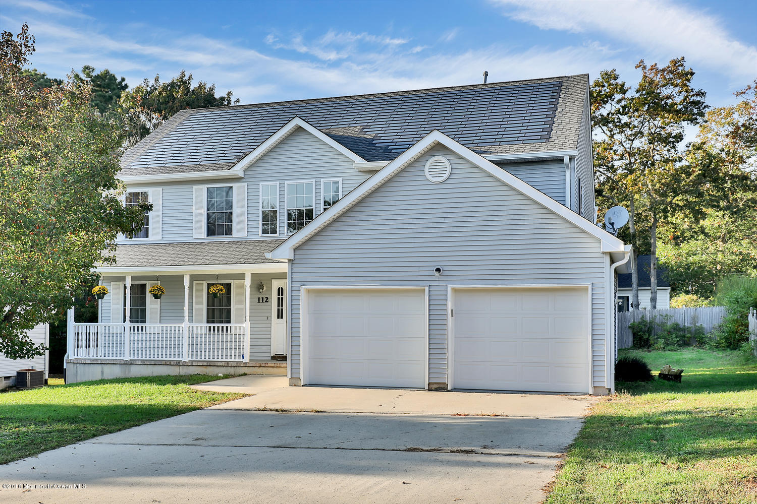 112 Seaspray Road Manahawkin, NJ 08050 - Photo 1 of 21 a front view of a house with a garden and yard