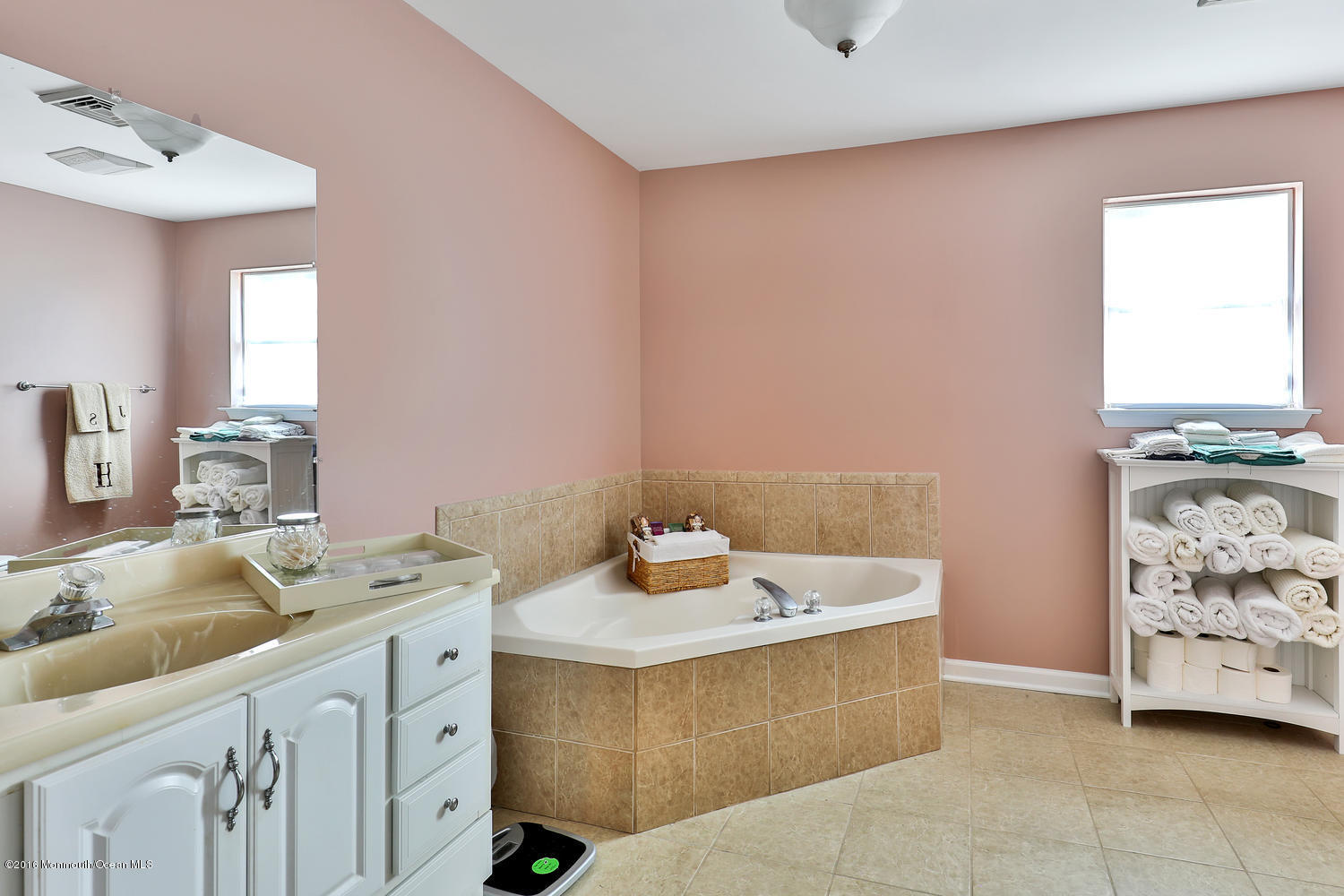 112 Seaspray Road Manahawkin, NJ 08050 - Photo 16 of 21 a bathroom with a sink a vanity and mirror