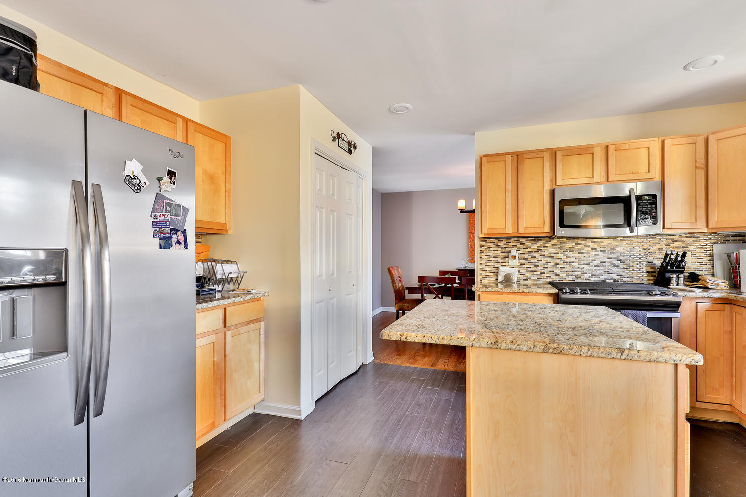 112 Seaspray Road Manahawkin, NJ 08050 - Photo 5 of 21 a large kitchen with a refrigerator a stove top oven a sink dishwasher and wooden cabinets