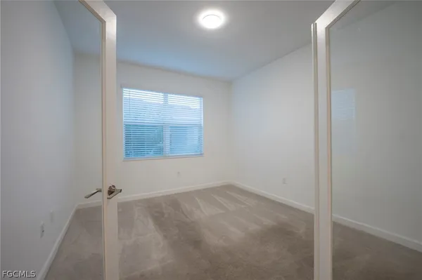 an aerial view of a house with a garden and lake view
