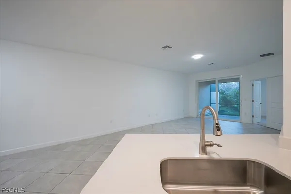 a bathroom with a shower sink and mirror