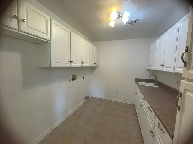 a view of a house with a small yard and floor to ceiling window