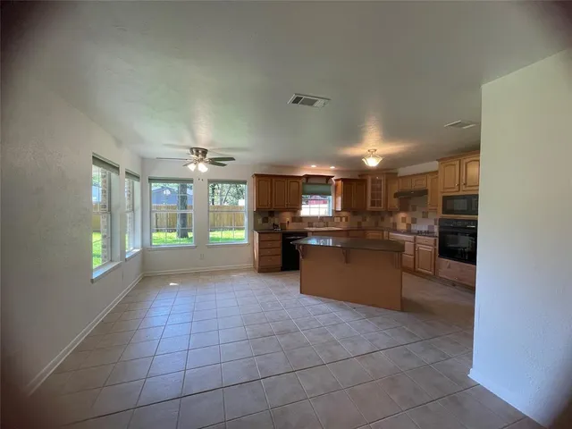 a large kitchen with a lot of cabinets and appliances