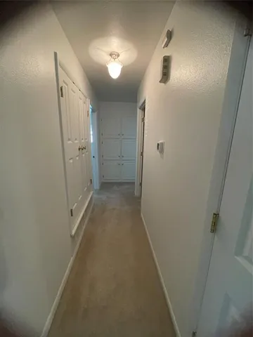 en empty room with windows and ceiling fan