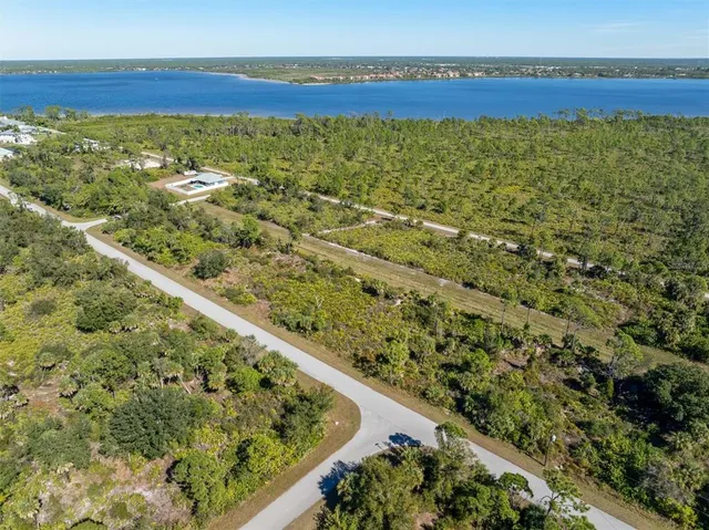a view of a field with an ocean view