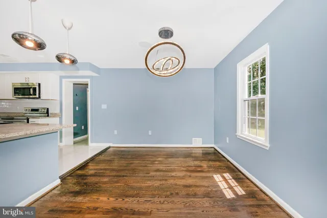 a view of room with window and hardwood floor