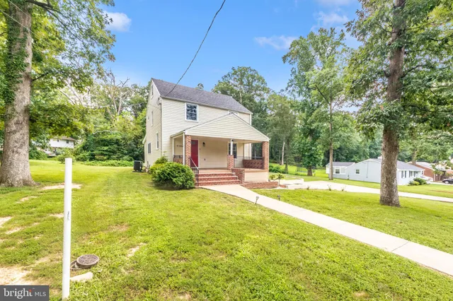 a view of a house with pool and a yard