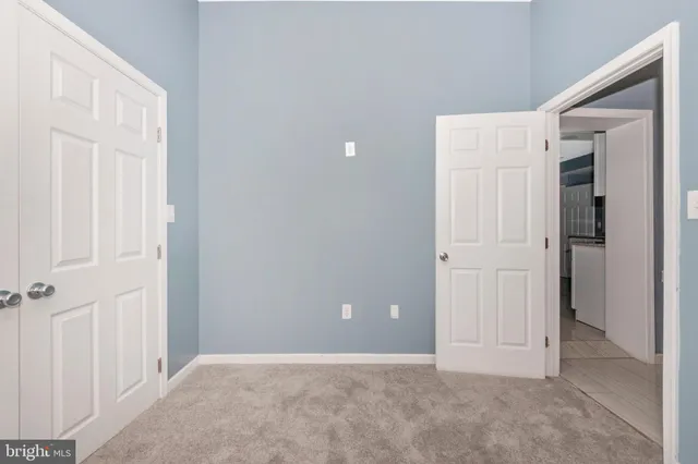 an empty room with closet area