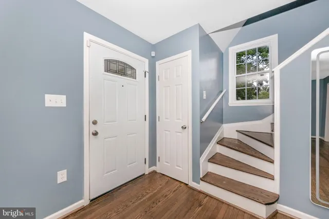 a view of entryway with wooden floor and stairs
