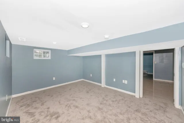 an empty room with closet and windows