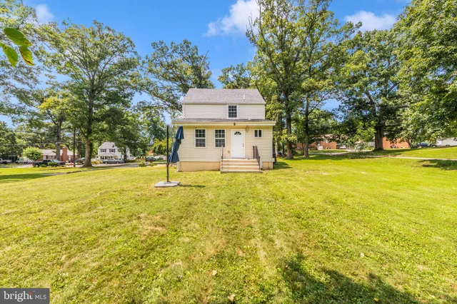 a house view with swimming pool in front of it