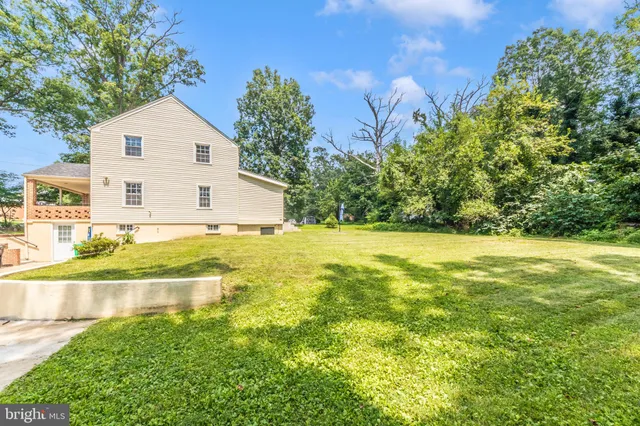 a view of backyard of house with green space
