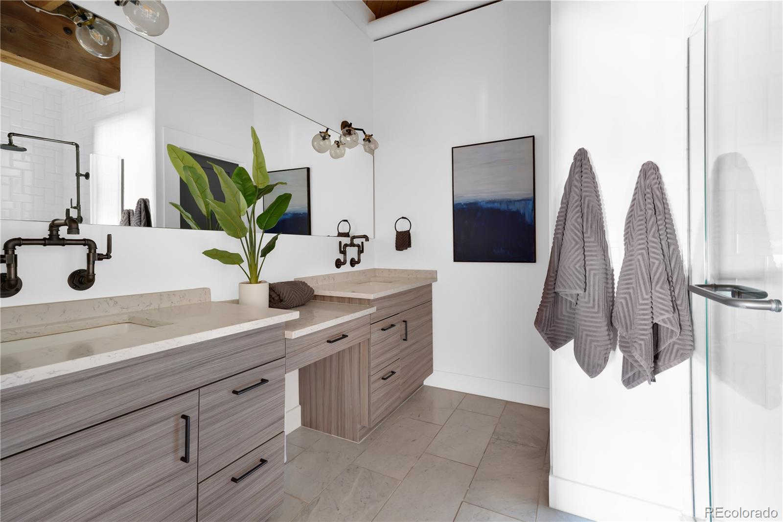 1792 Wynkoop Street, Unit 307 Denver, CO 80202 - Photo 11 of 26 a bathroom with a double sink mirror and shower