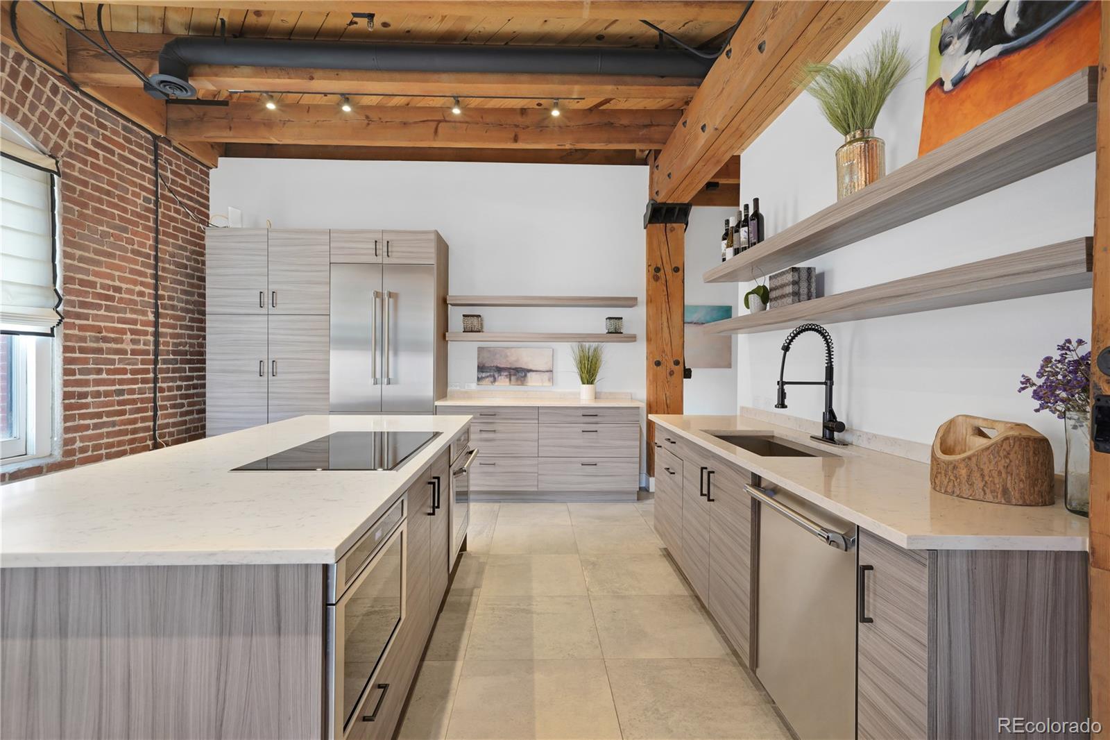 1792 Wynkoop Street, Unit 307 Denver, CO 80202 - Photo 3 of 26 a kitchen with granite countertop a sink and dishwasher a stove top oven with wooden floor