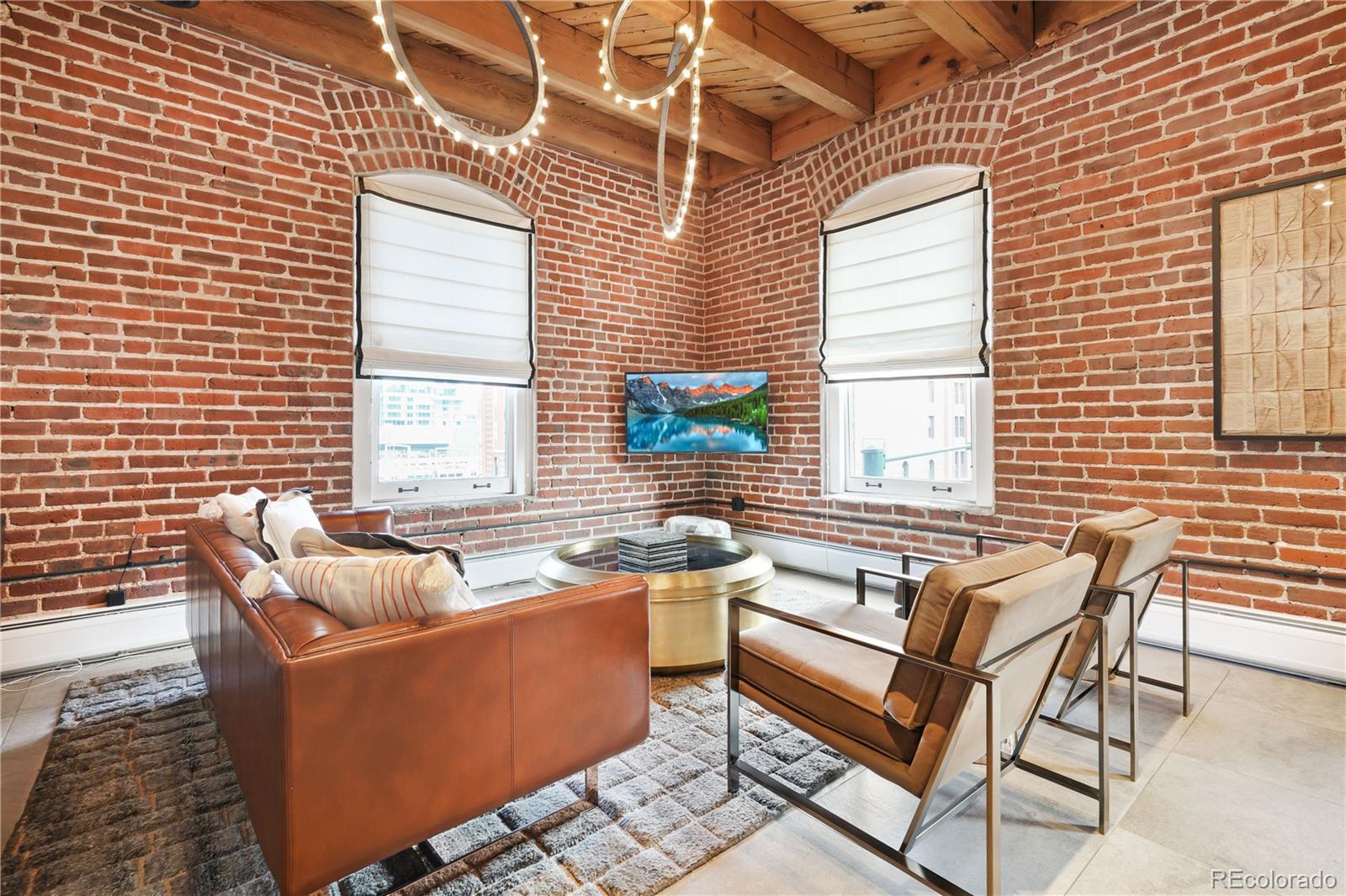 1792 Wynkoop Street, Unit 307 Denver, CO 80202 - Photo 5 of 26 a living room with furniture and a window