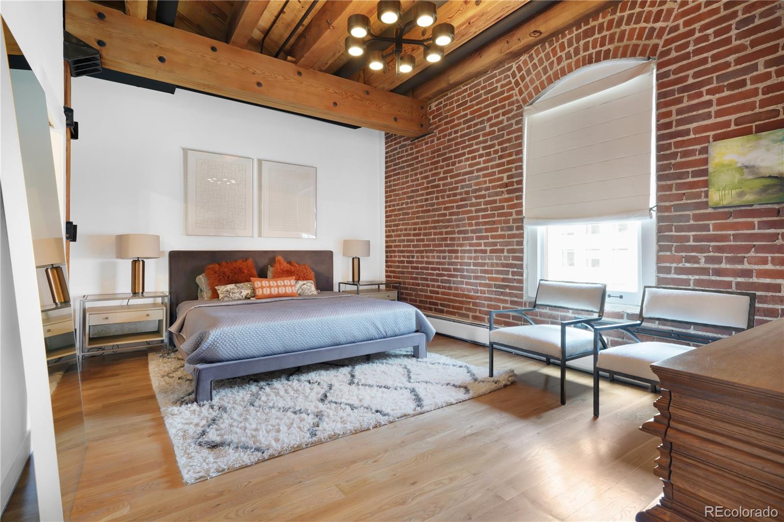 1792 Wynkoop Street, Unit 307 Denver, CO 80202 - Photo 8 of 26 a bedroom with furniture and a large window