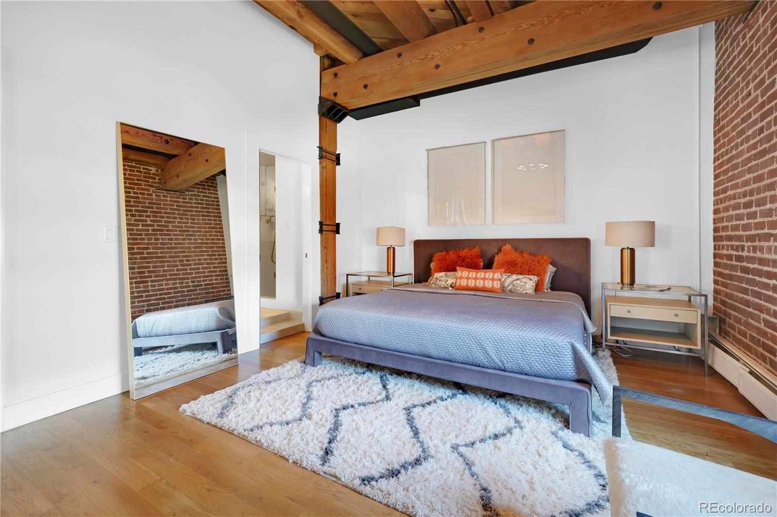 1792 Wynkoop Street, Unit 307 Denver, CO 80202 - Photo 9 of 26 a bedroom with a bed and wooden floor