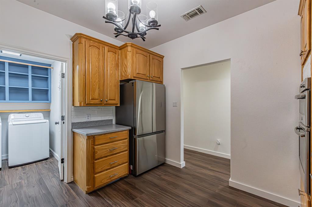 204 Spring Branch Trail South Springtown, TX 76082 - Photo 21 of 39 Kitchen area featuring wood-finish flooring and light wood cabinetry with brushed nickel hardware